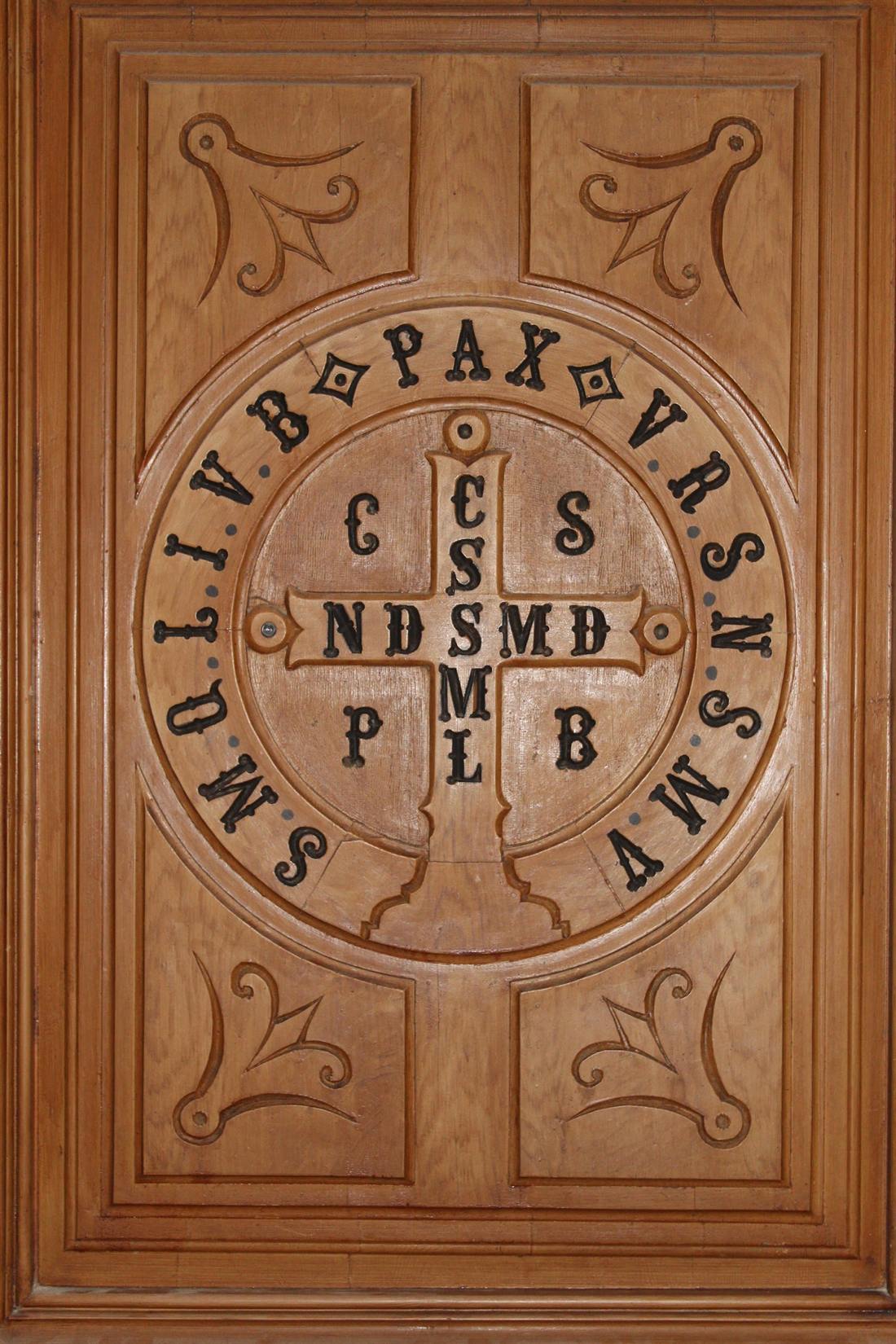 Door carved with the medal of Saint Benedict